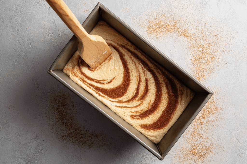 Batter Being Swirled With Cinnamon Sugar In Loaf